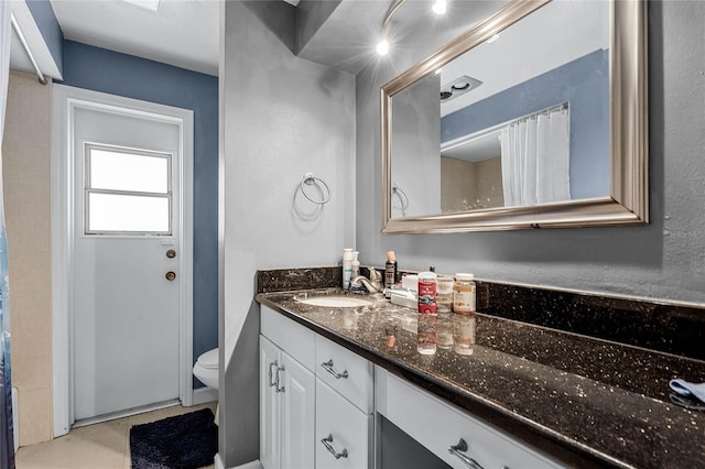 bathroom featuring vanity and toilet