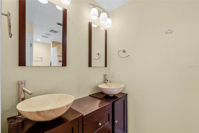 bathroom featuring vanity and curtained shower