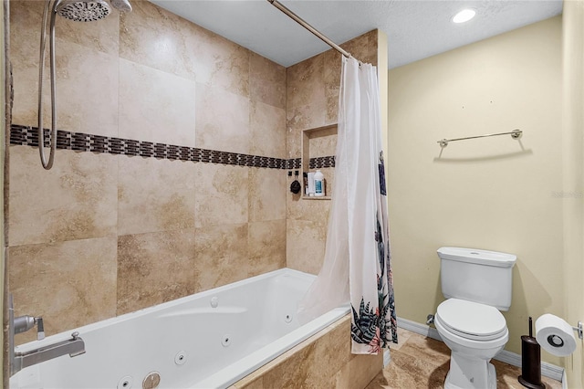 bathroom featuring shower / tub combo and toilet