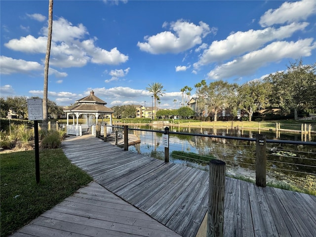 view of dock with a gazebo and a water view