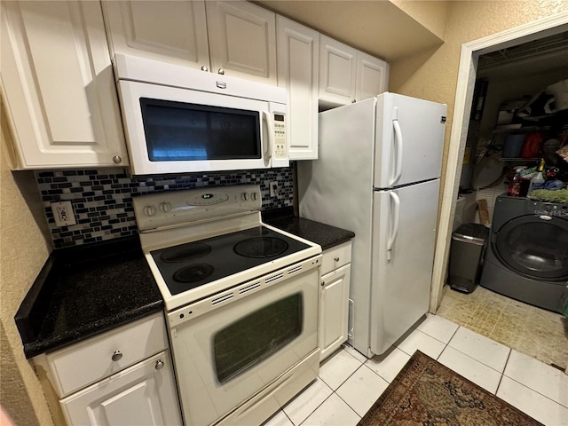 kitchen with washer / dryer, backsplash, white cabinets, light tile patterned floors, and white appliances