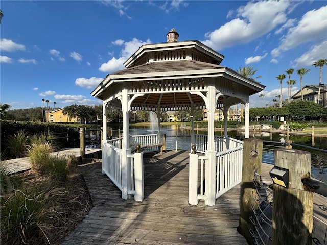 view of dock with a gazebo and a water view