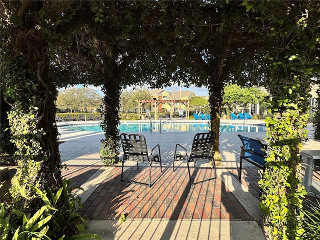 exterior space with a community pool and a patio