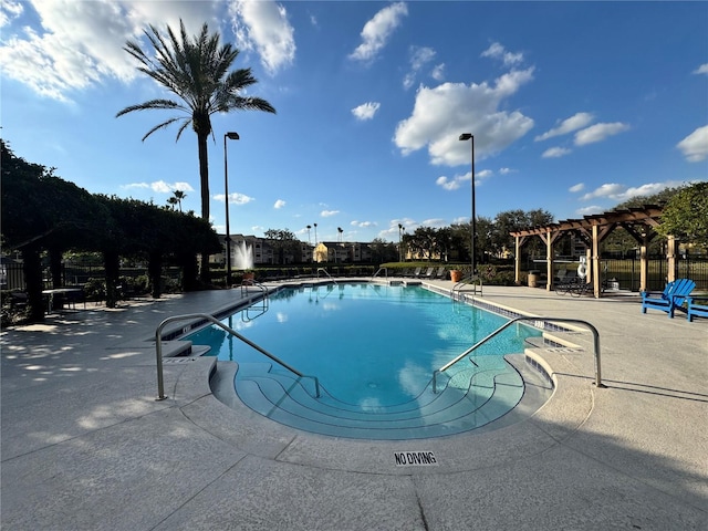 view of swimming pool featuring a patio and a pergola