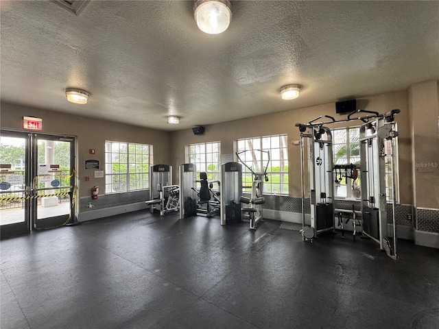 2328 Midtown Ter Unit 1024, Orlando, FL 32839 - exercise room featuring a textured ceiling