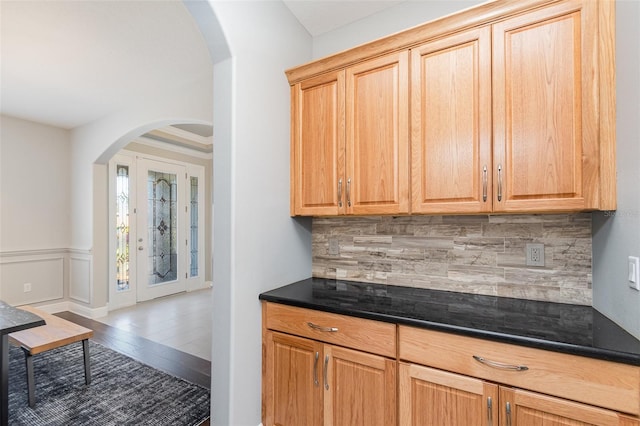 bar featuring tasteful backsplash and hardwood / wood-style flooring