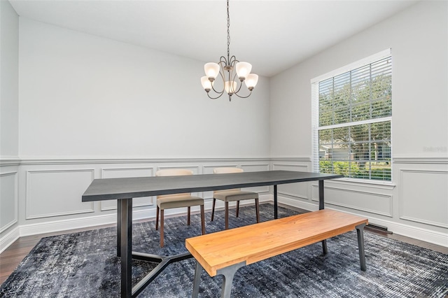 dining room with an inviting chandelier and dark hardwood / wood-style flooring