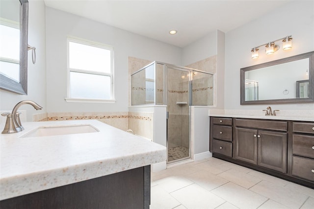 bathroom featuring vanity, tile patterned flooring, and walk in shower