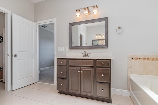 bathroom featuring vanity, tile patterned flooring, and a bathtub