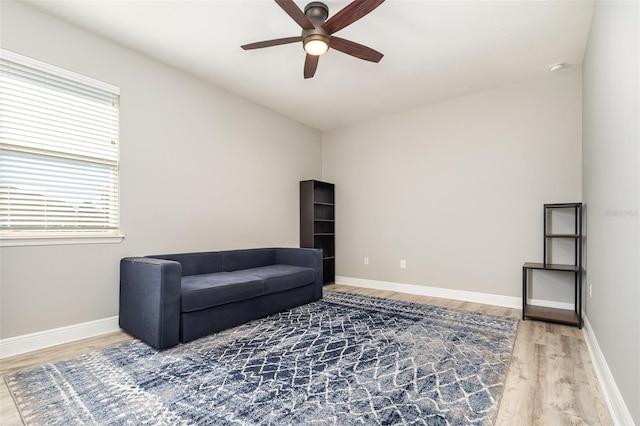 sitting room with wood-type flooring and ceiling fan