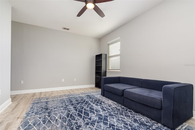 living room with ceiling fan and wood-type flooring