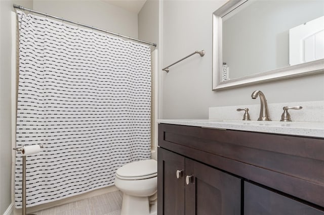 bathroom featuring vanity, walk in shower, tile patterned floors, and toilet