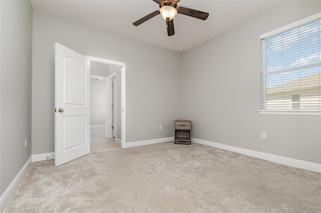 unfurnished bedroom with ceiling fan and light carpet