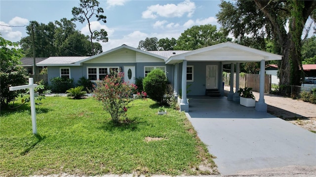 single story home featuring a carport and a front lawn