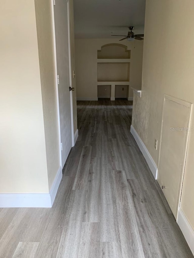 corridor with hardwood / wood-style flooring