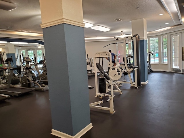 exercise room with a wealth of natural light and a textured ceiling