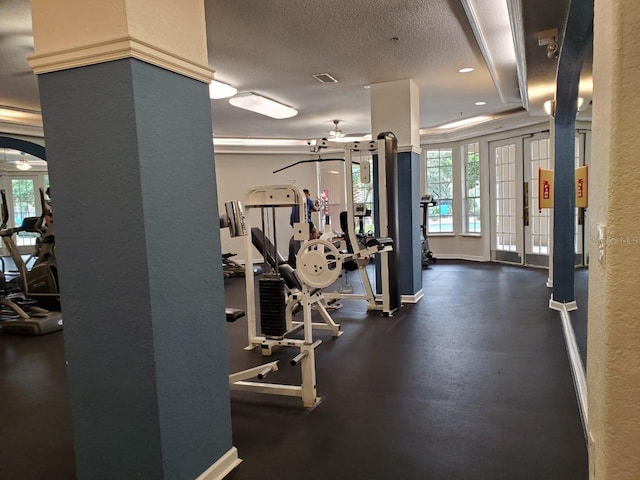 workout area with french doors and a textured ceiling