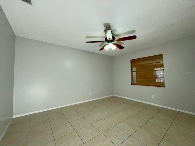 unfurnished room featuring light tile patterned floors and ceiling fan