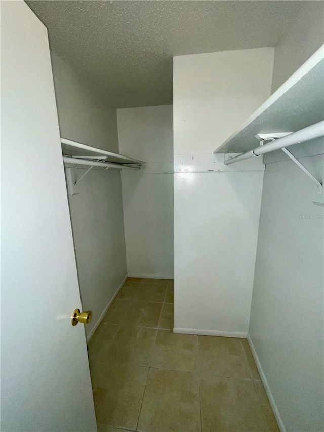 walk in closet featuring light tile patterned flooring