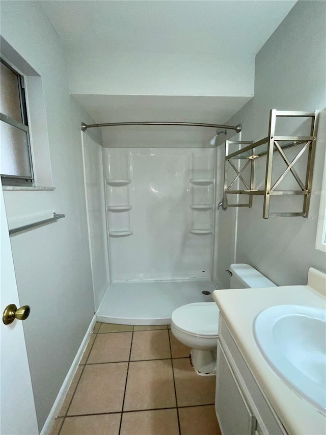 bathroom featuring walk in shower, tile patterned floors, toilet, and vanity