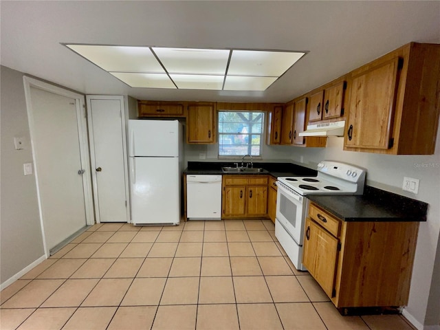 kitchen featuring white appliances, sink, and light tile patterned floors