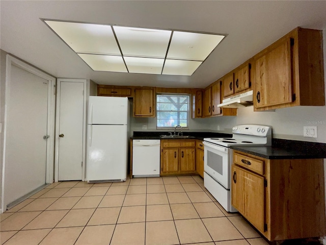 kitchen featuring light tile patterned flooring, sink, and white appliances