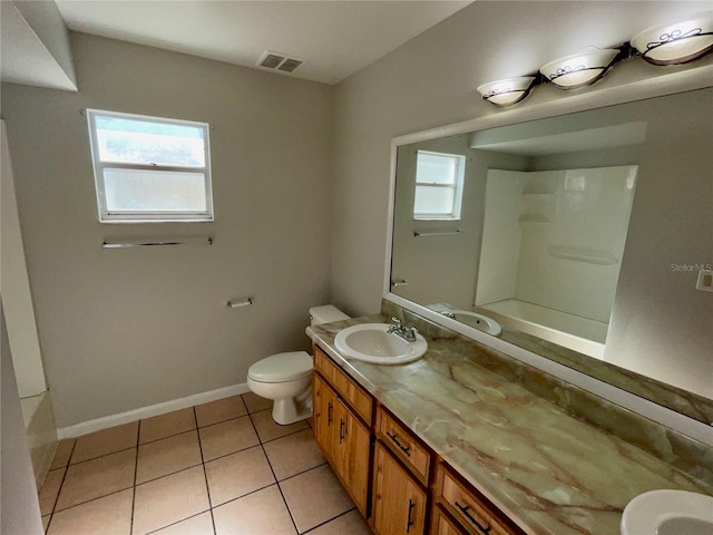 bathroom featuring vanity, toilet, and tile patterned flooring