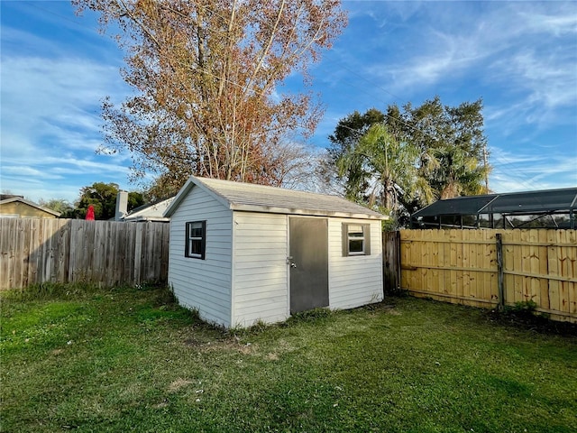 view of outbuilding with a yard