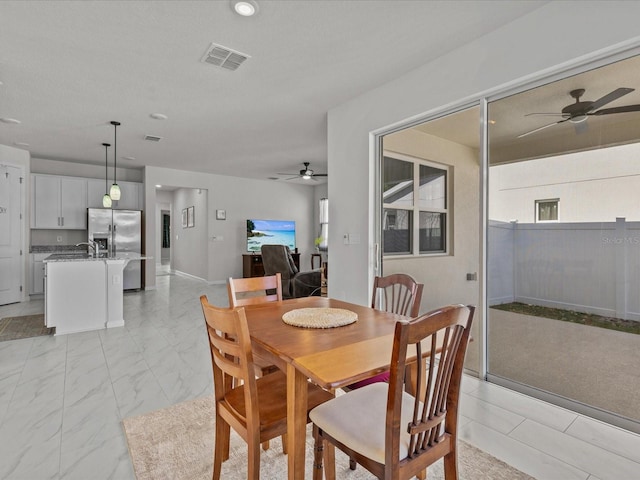 dining area with ceiling fan