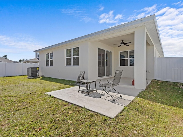 rear view of house featuring a yard, central AC unit, ceiling fan, and a patio area