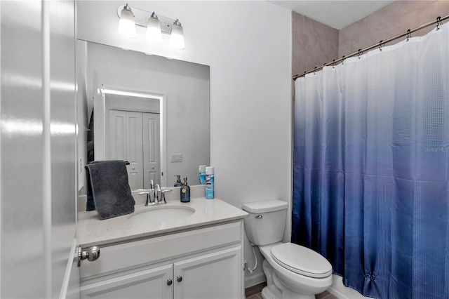 bathroom featuring vanity, a shower with curtain, and toilet