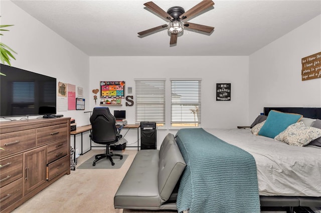 carpeted bedroom with ceiling fan and a textured ceiling