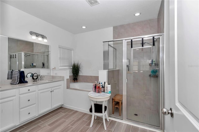 bathroom with vanity and plus walk in shower