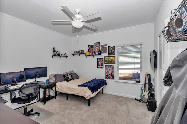 bedroom featuring ceiling fan, light colored carpet, and a textured ceiling