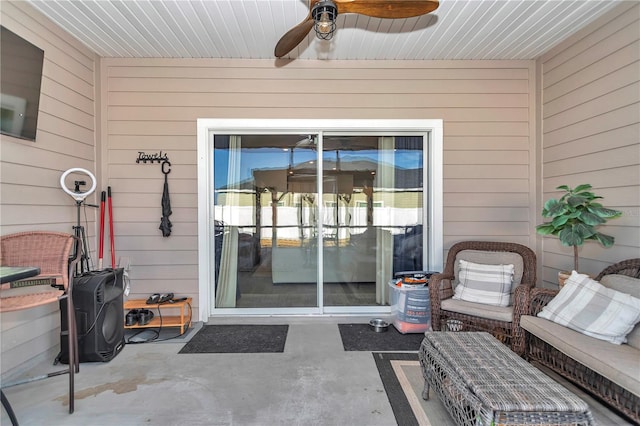 entrance to property with a patio, outdoor lounge area, and ceiling fan