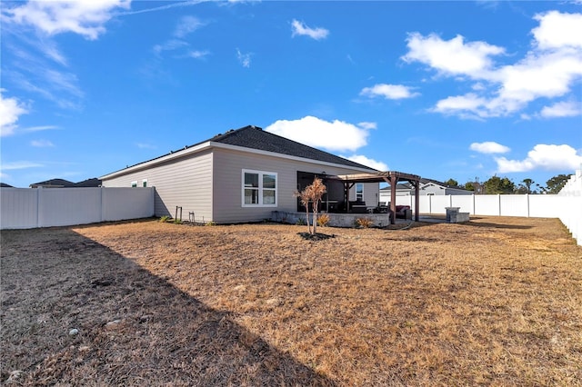 rear view of property featuring a lawn