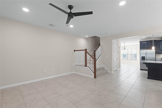 empty room featuring light tile patterned floors and ceiling fan