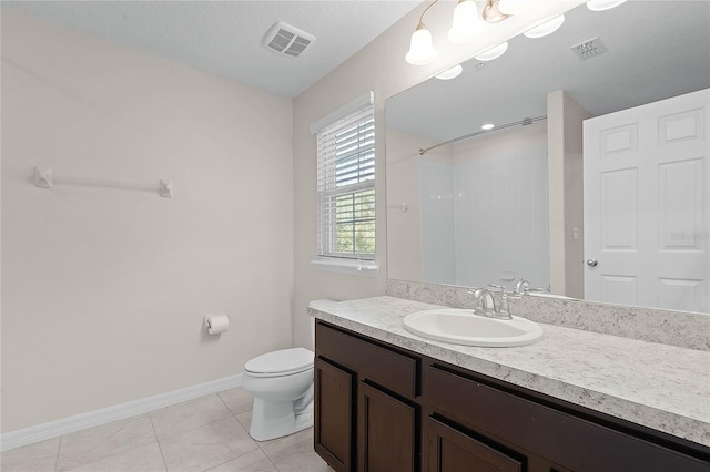 bathroom with walk in shower, toilet, a textured ceiling, vanity, and tile patterned flooring