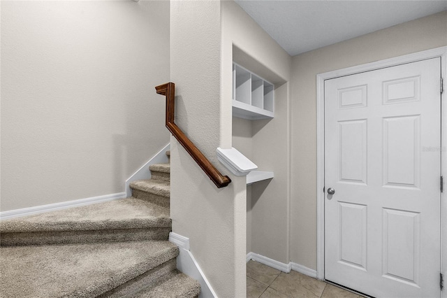 stairs with tile patterned floors