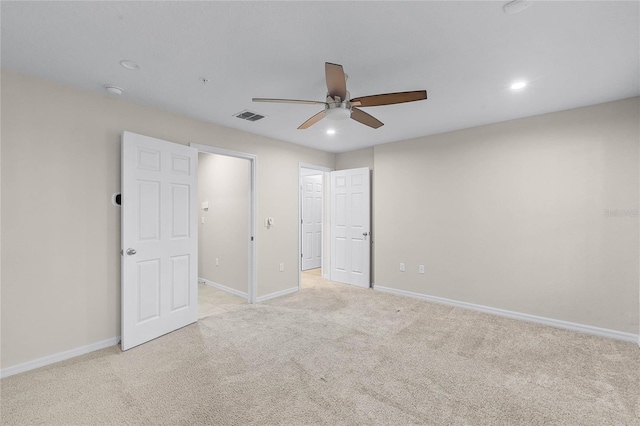 unfurnished bedroom with light colored carpet and ceiling fan