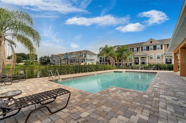 view of swimming pool featuring a patio area