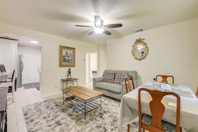 tiled living room with ceiling fan