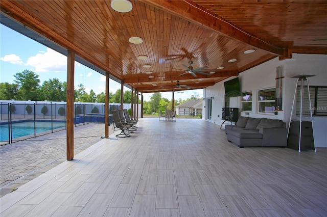 view of patio with a fenced in pool, outdoor lounge area, and ceiling fan