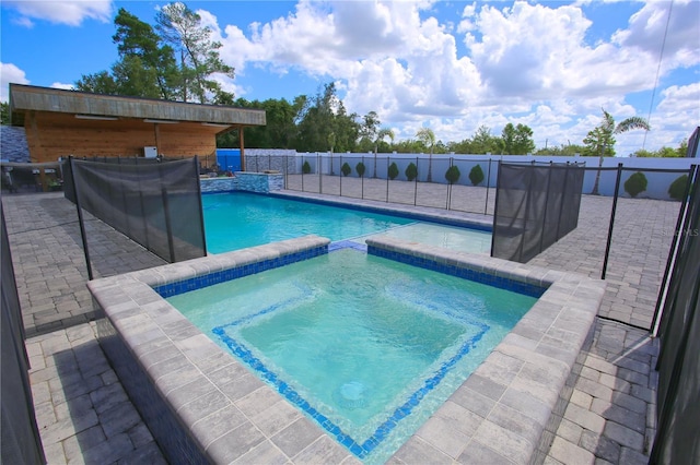 view of swimming pool featuring an in ground hot tub