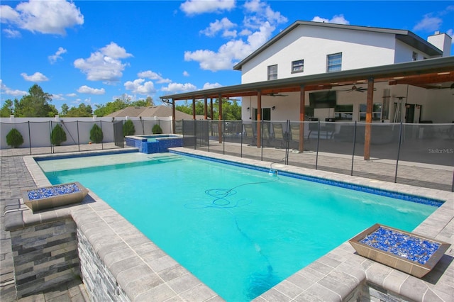 view of pool featuring an in ground hot tub, ceiling fan, and a patio