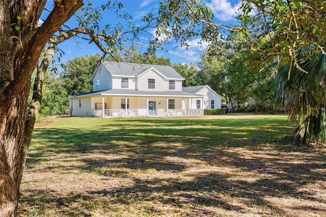 country-style home featuring covered porch and a front lawn