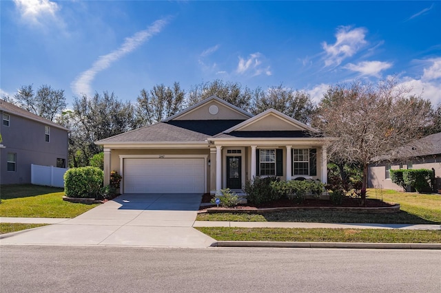 view of front of property featuring a garage and a front lawn