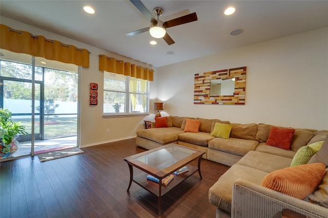 living room featuring dark wood-type flooring and ceiling fan