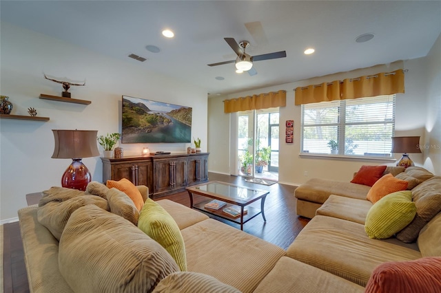 living room with wood-type flooring and ceiling fan