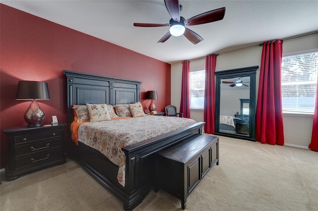 bedroom with light carpet, access to exterior, and ceiling fan